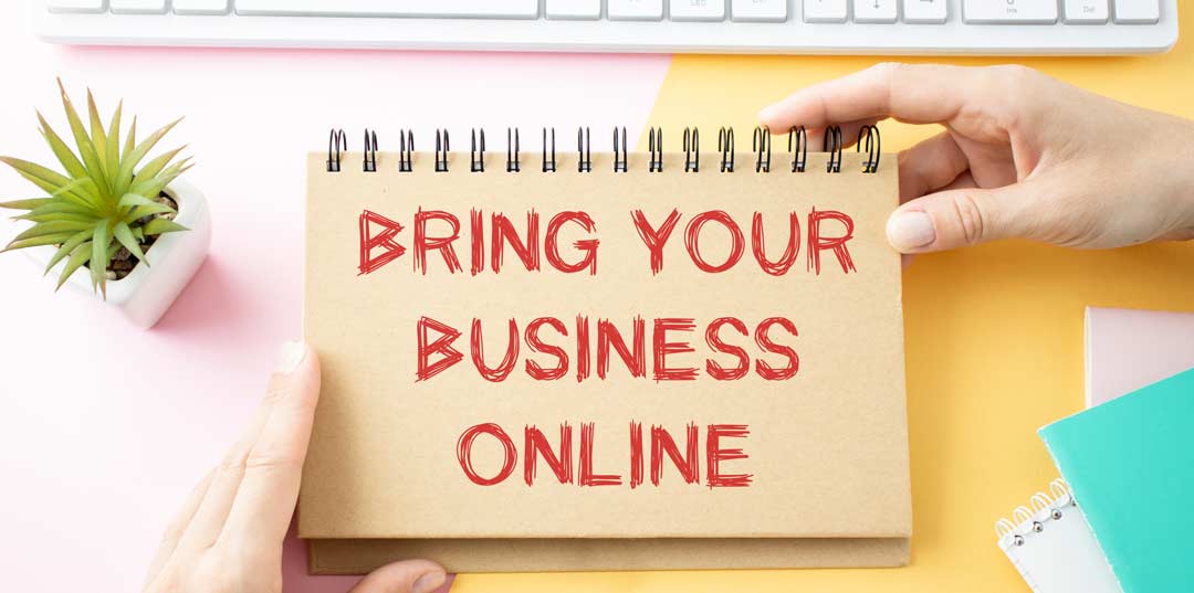 Image of hand written words on the back of a notebook that says "bring your business online"
